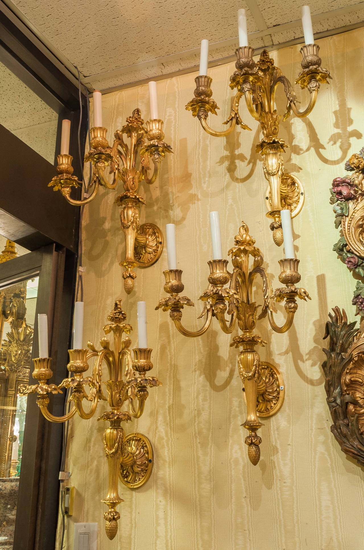 Exquisite Set of Four Gilt Bronze Three-Arm Louis XVI Style Wall Lights In Good Condition In New York, NY