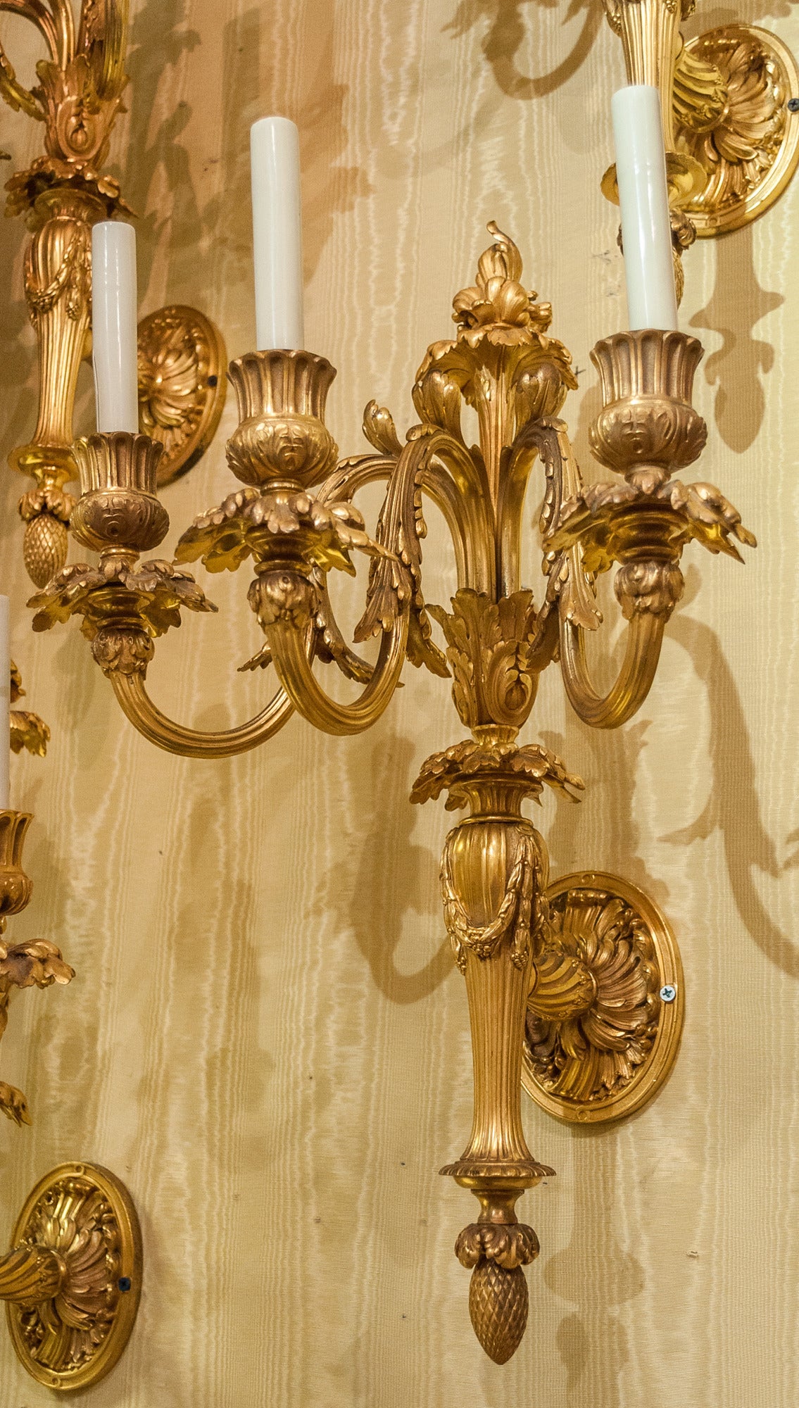 French Exquisite Set of Four Gilt Bronze Three-Arm Louis XVI Style Wall Lights
