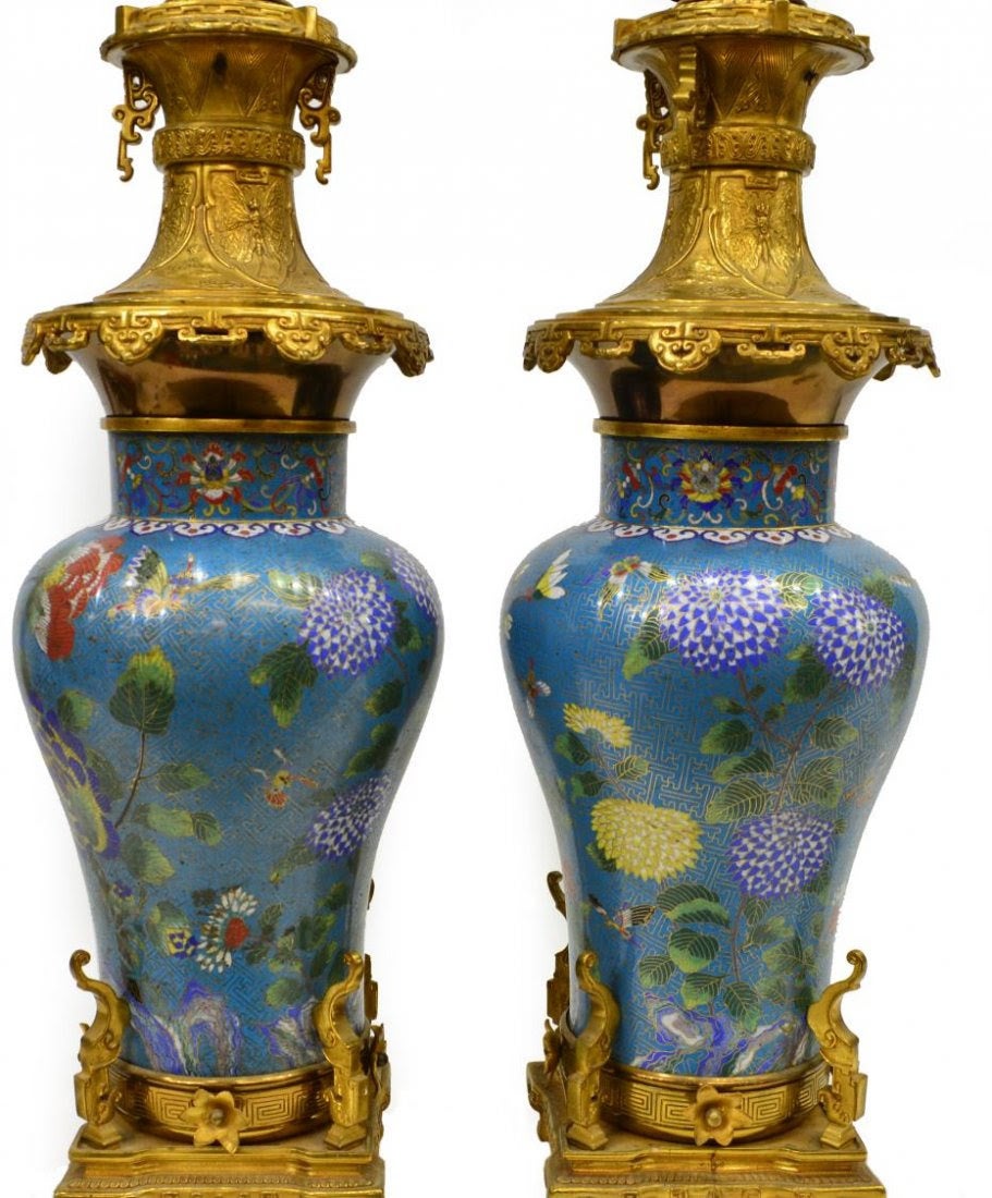 Pair of Chinese cloisonne enamel baluster form vases, now mounted as table lamps, scholar's rock and butterflies on a turquoise diaper ground, lotus scroll and ruyi motif along rim, gilt metal base and top, one lacking finial.
Stock Number: A5