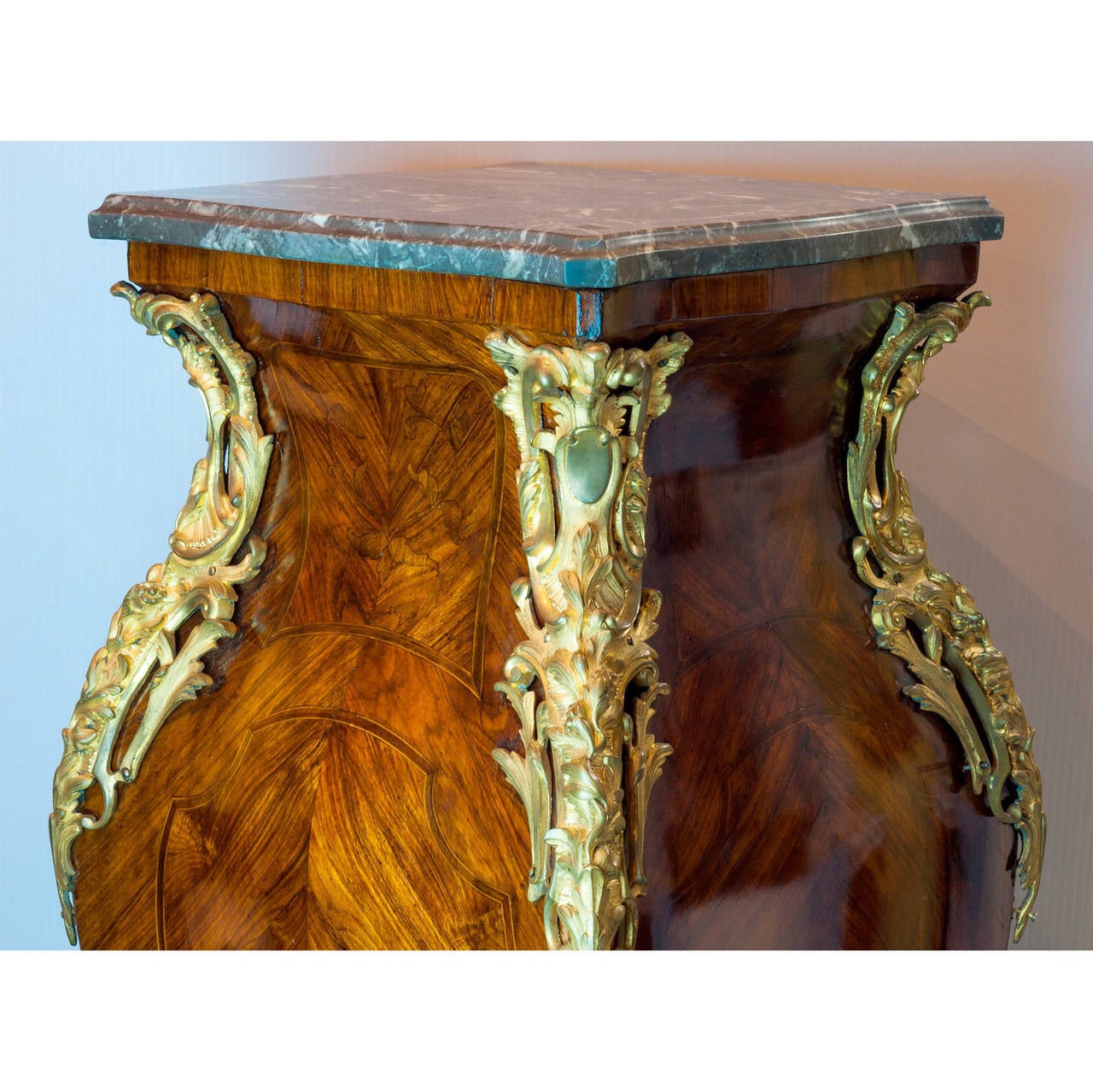 A Louis XV style bronze mounted square form pedestal with parquetry and marquetry inlaid design.