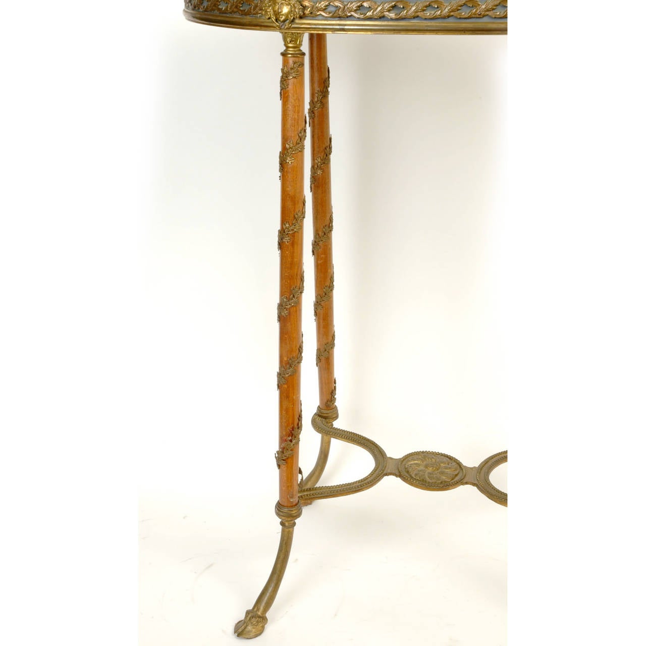A fine Louis XVI style bronze-mounted marble-top oval side table with mask face motif
Stock number: F87.
