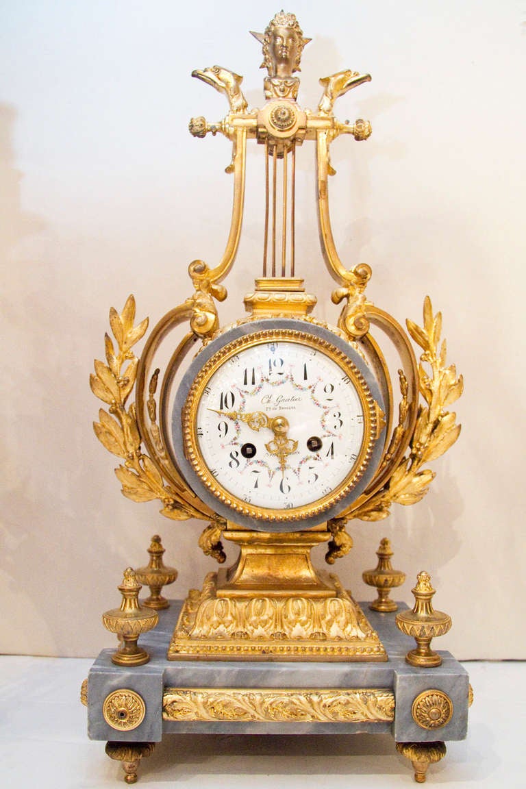 A very fine quality French 19 century  Louis XVI style Bleu Turquin marble and gilt bronze lyre shape clock  set . Dial signed G. Gauthier