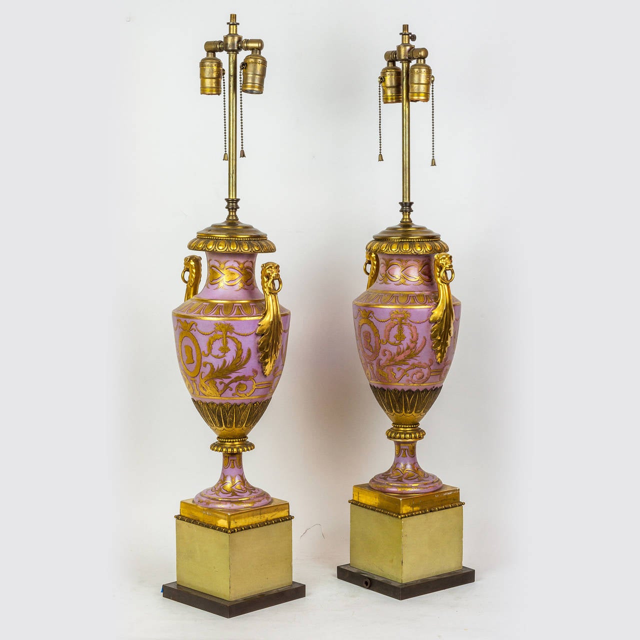 A fine pair of neoclassical gold painted porcelain lamps on wood base.
Stock number: LL22.