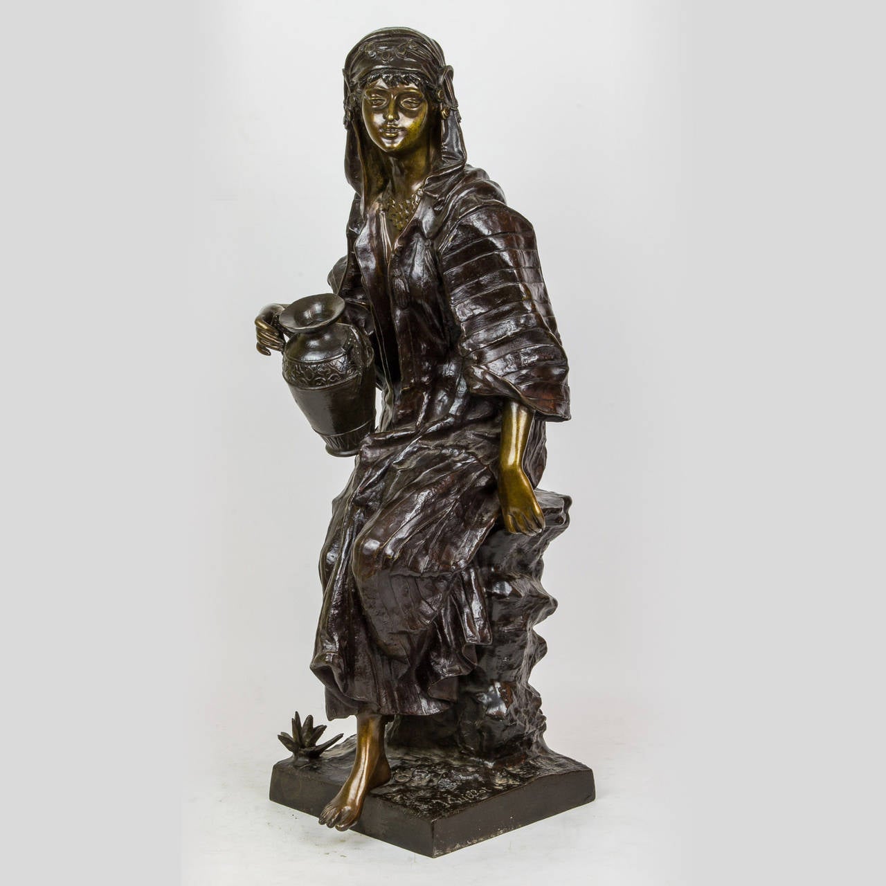 A Fine Orientalist Bronze Figure of a Gypsy seated on Rocks Holding Water Jug signed J. Guellot
Stock Number: SC90