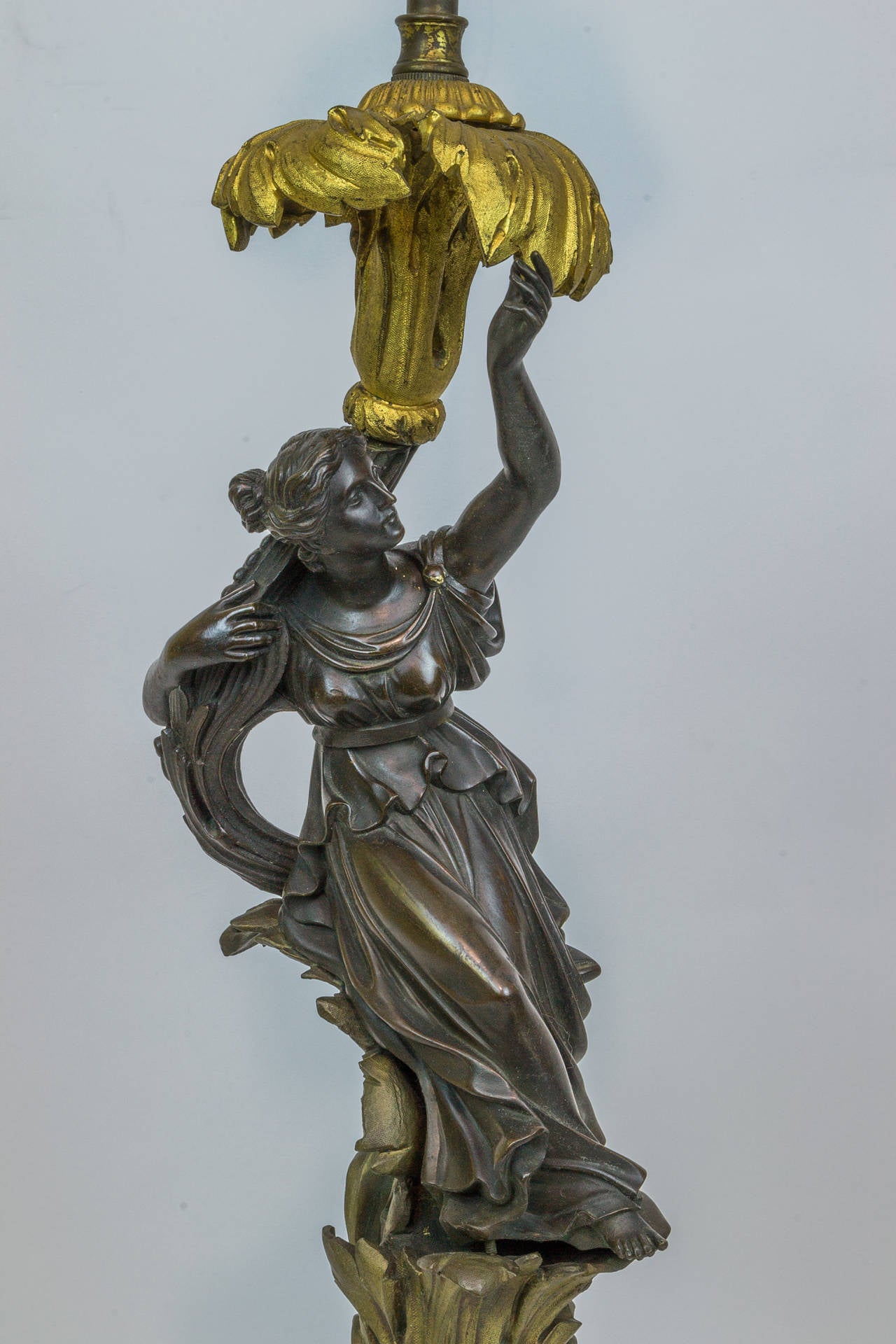 A Fine Pair of Patinated and Gilt Bronze Figural Candlestick Lamps
Stock Number: LL30