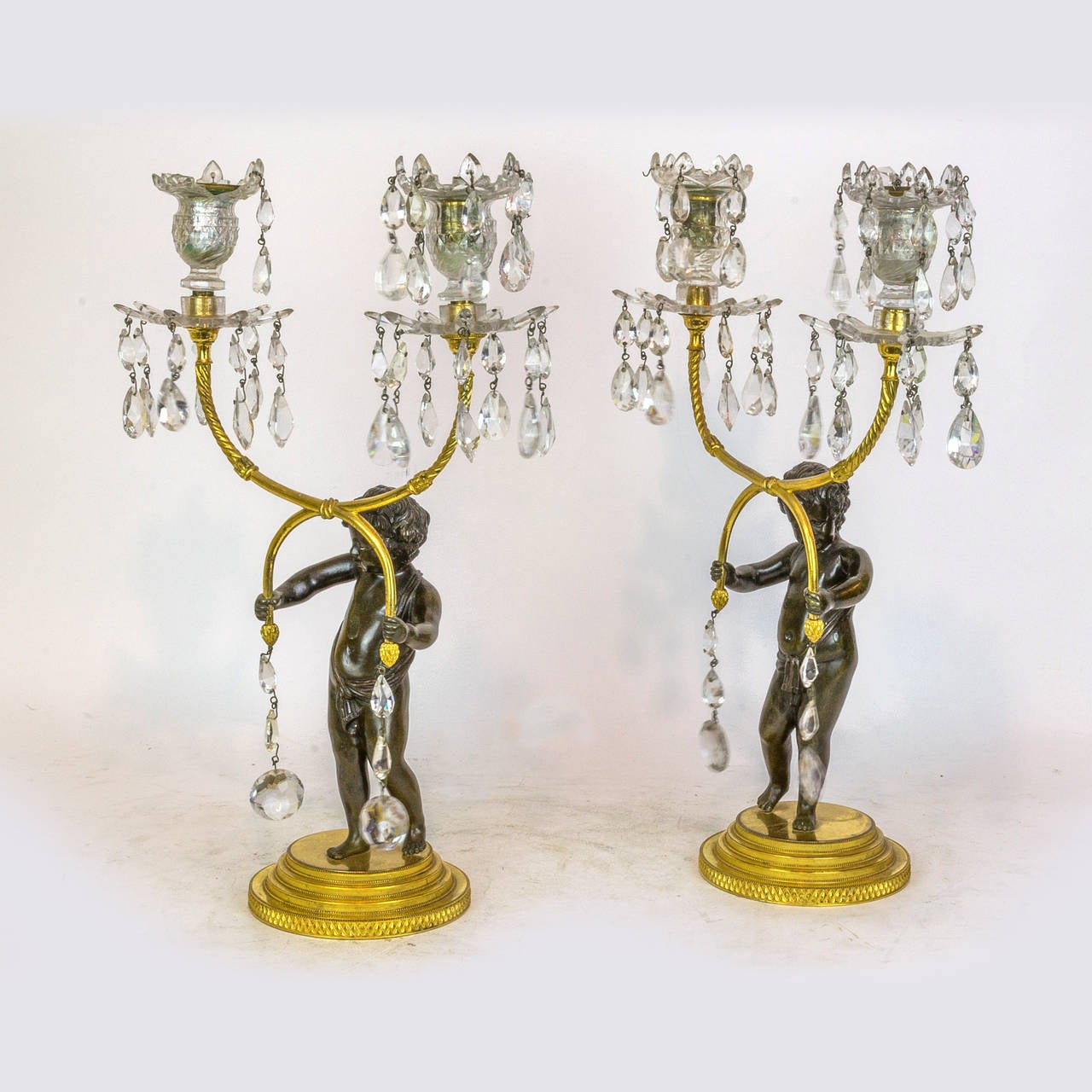 Pair of Patinated and Gilt Bronze and Crystal Figural Candelabras