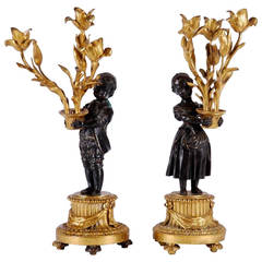 Antique Pair of Candelabras Depicting Two Children on Plinths Holding Potted Flowers