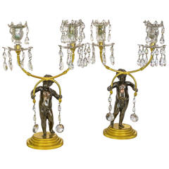 Pair of Patinated and Gilt Bronze and Crystal Figural Candelabras