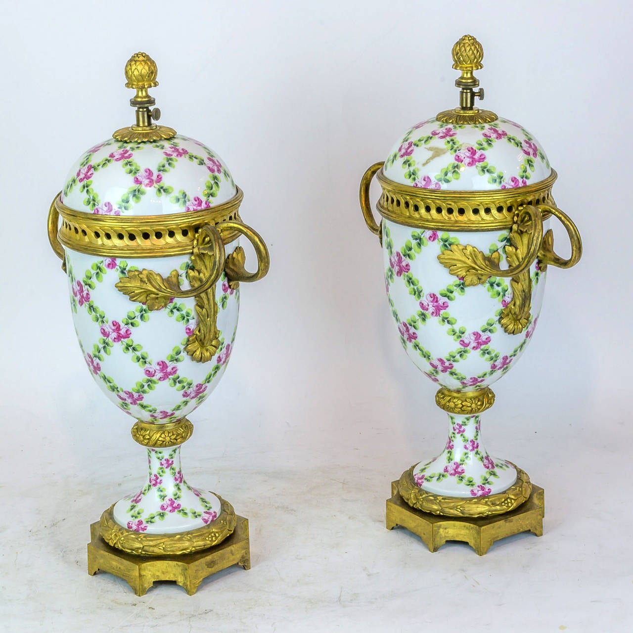 Pair of Floral Painted Porcelain and Bronze Covered Urns In Excellent Condition In New York, NY