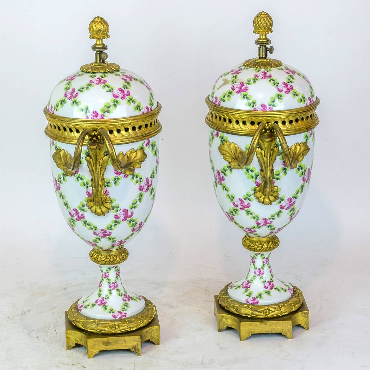 19th Century Pair of Floral Painted Porcelain and Bronze Covered Urns
