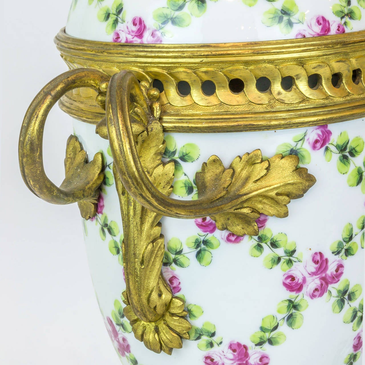 A pair of floral painted porcelain and bronze covered urns.
Stock number: DA87.