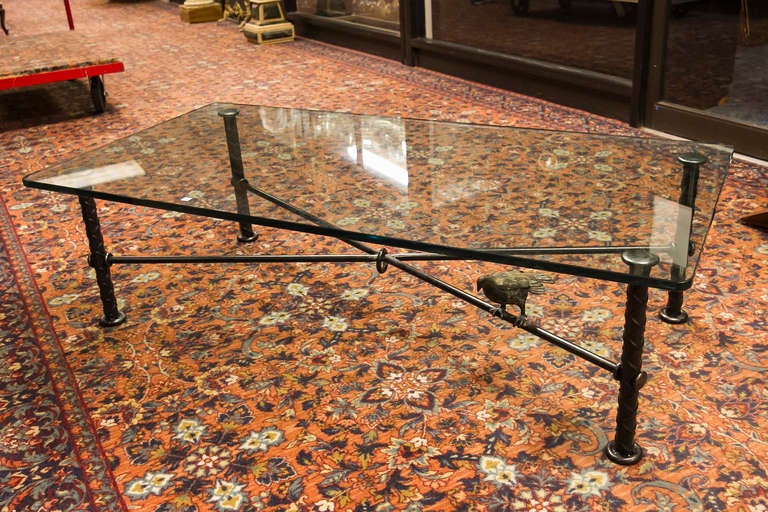 A bronze glass top coffee table by Ilana Goor , with bird Motifs.