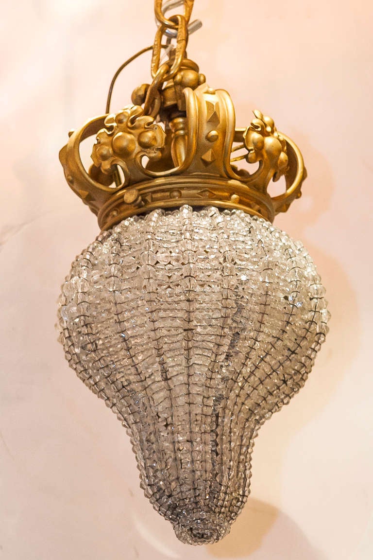 A Small Beaded Crystal and Bronze Chandelier