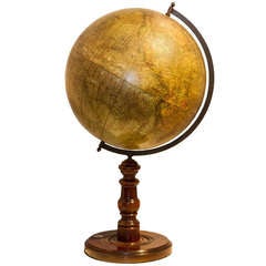 A desk globe on wooden base with compass