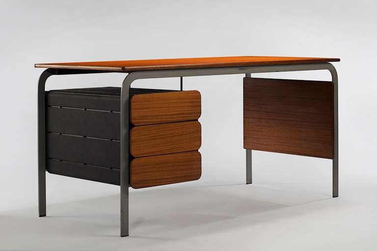 Desk by Jean Claude Duboys of 1967, in teak, aluminium, and black plastic with a top in orange formica and mahogany. Designed for Huchers Minvielle France.