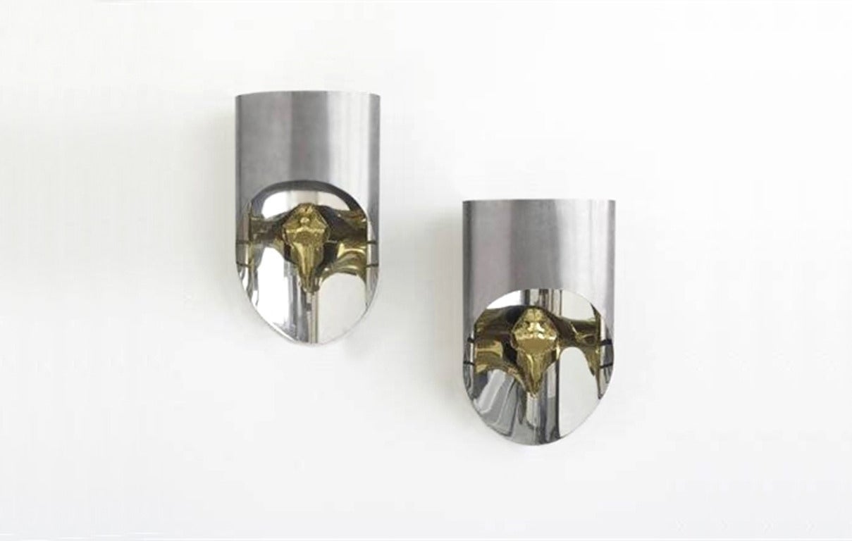 Stainless steel and bronze sconces by Maria Pergay.

Literature: Demisch, Suzanne, Maria Pergay: Between Ideas and Design, Demisch Danant 2006, p.63.

About the designer: Maria Pergay (1930 -) exhibited her first collection of stainless steel