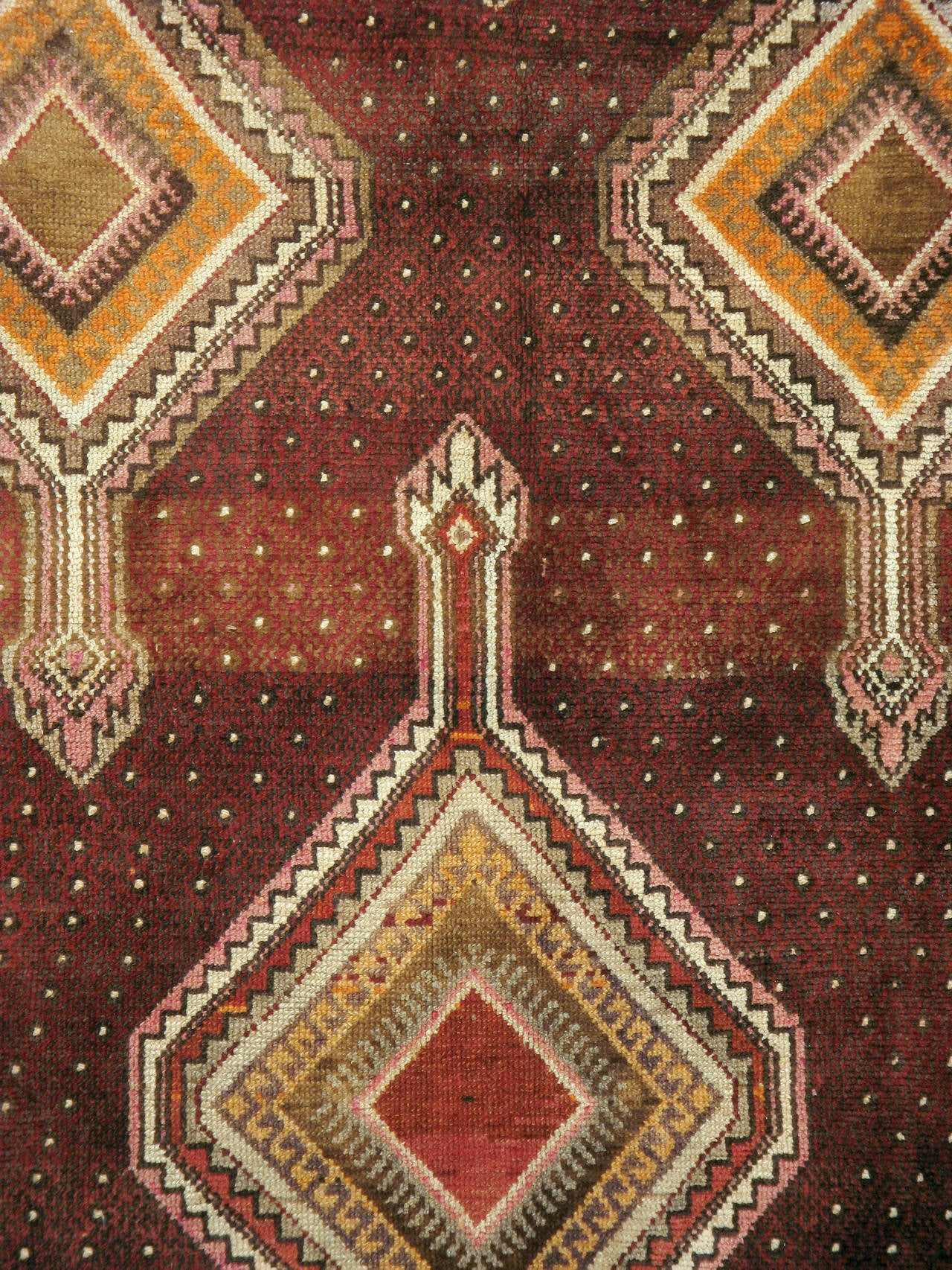 Vintage Turkish Anatolian rug a vintage Turkish Anatolian carpet from the second quarter of the 20th century with chic geometric motifs over a Marsala background.
