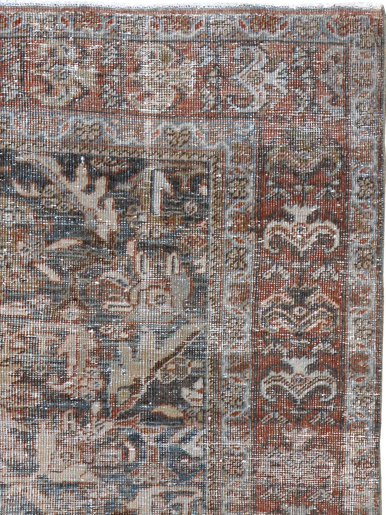 An antique Persian Mahal carpet with a weathered and distressed appeal from the first quarter of the 20th century.