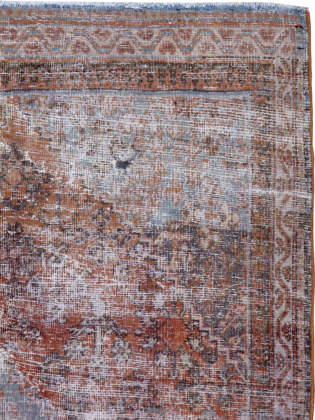 A weathered and distressed antique Persian Joshegan carpet from the first quarter of the 20th century.