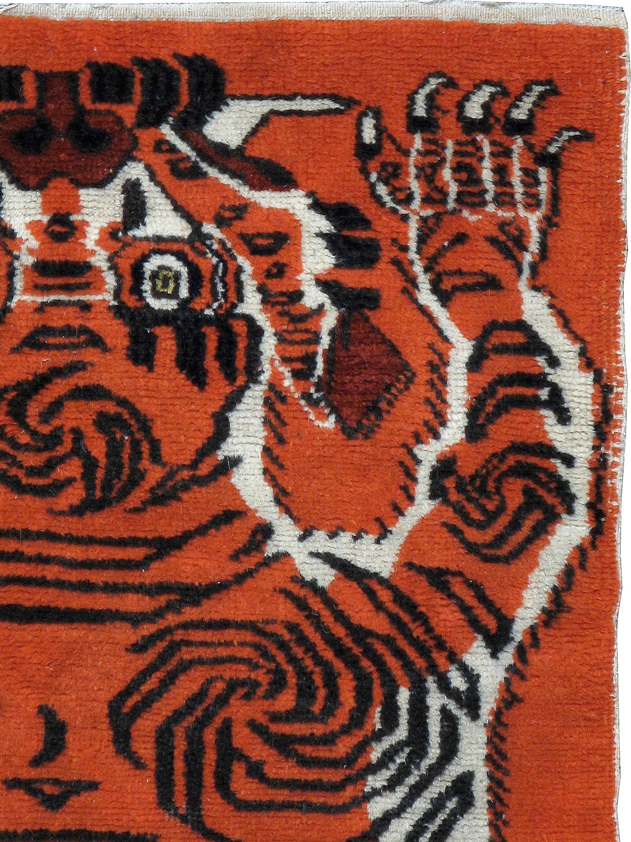 An antique Tibetan pictorial carpet of a tiger hide.