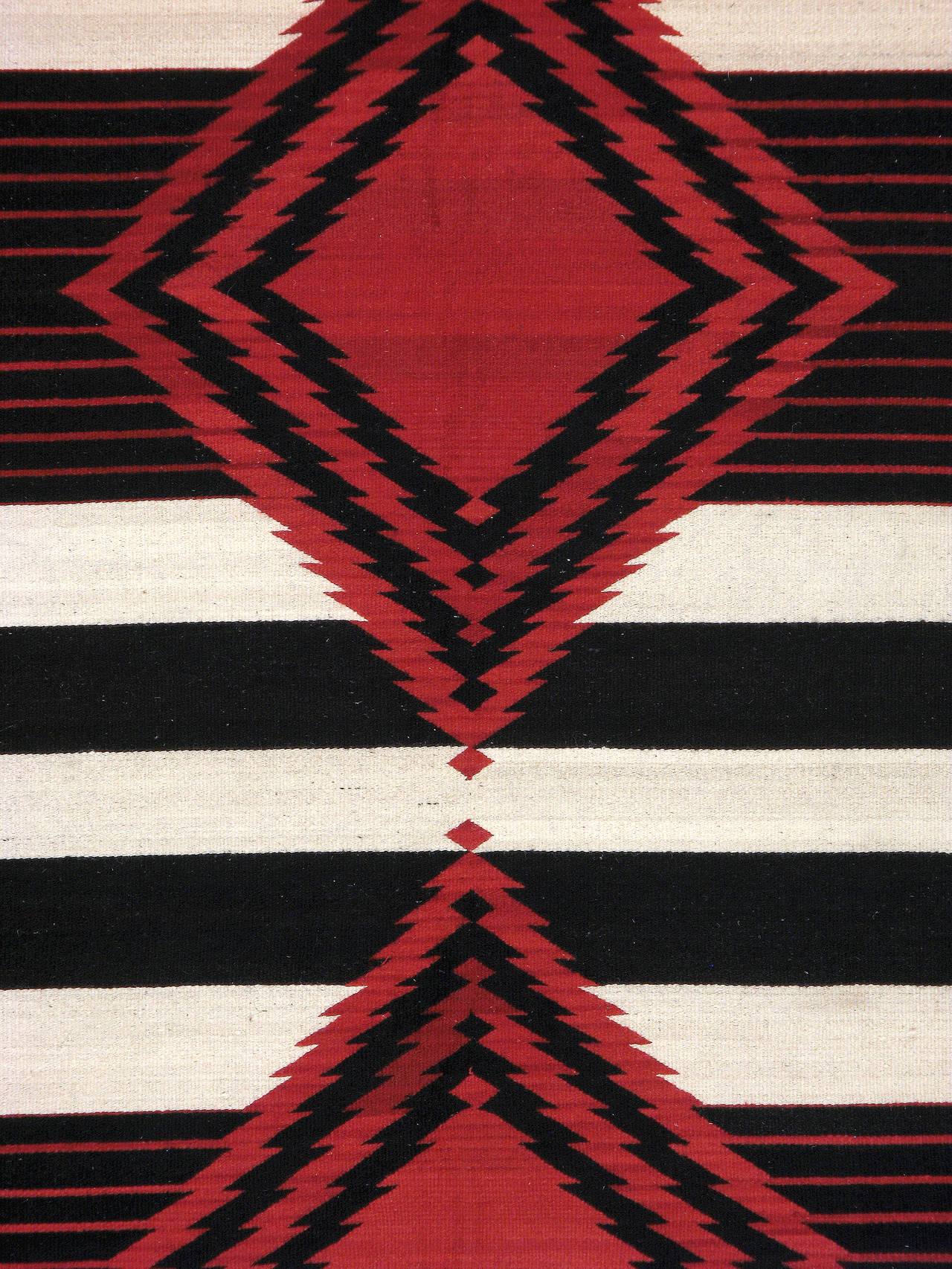 A vintage American Navajo flat-woven carpet from the second quarter of the 20th century.