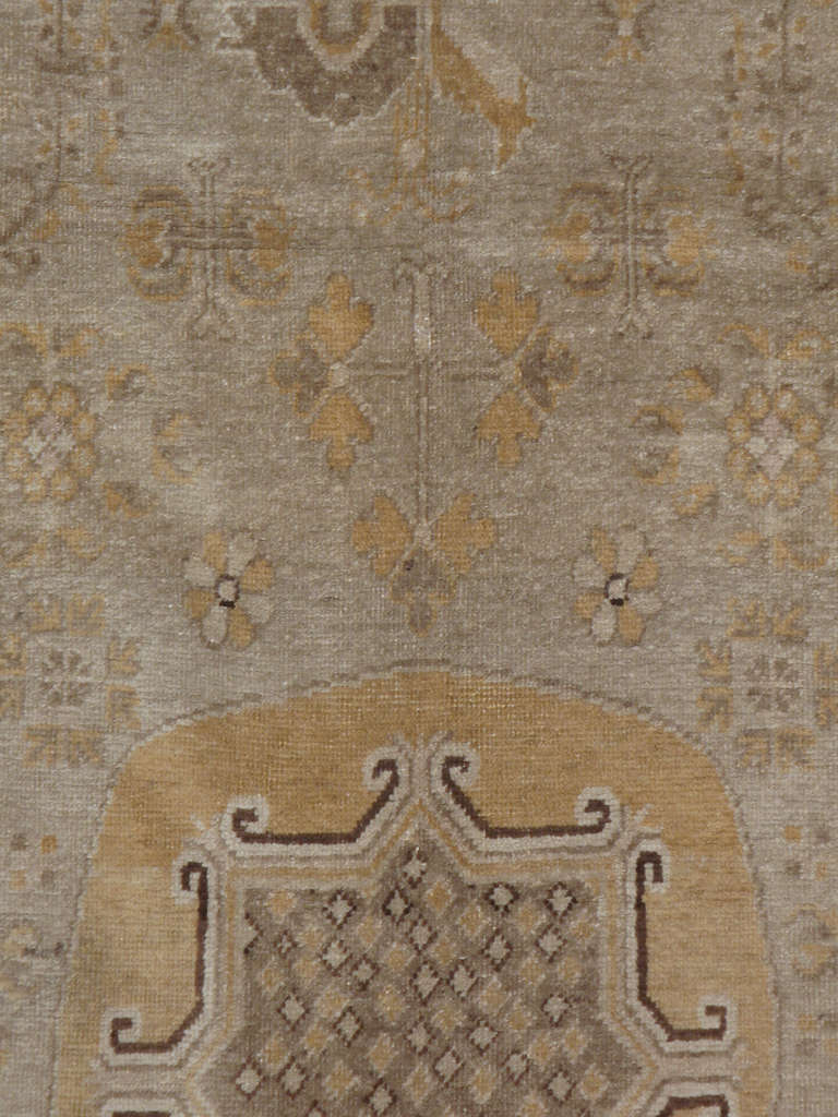Un Khotan du Turkestan oriental du début du 20ème siècle.  Les tapis et moquettes anciens de Khotan étaient produits dans la ville oasis du Turkestan oriental, qui fait aujourd'hui partie de la région du Xinjiang, dans l'ouest de la Chine.  Cette