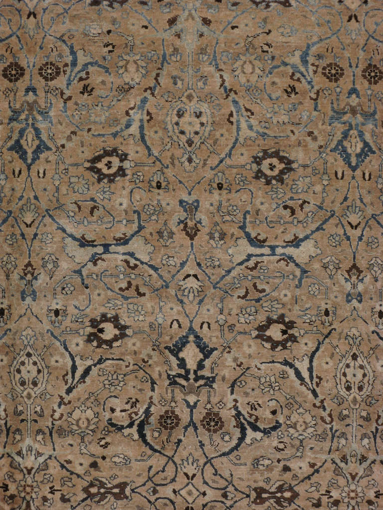 An early 20th century Persian Tabriz.  	Since the 17th century, Iran started exporting artisan carpets around the world, especially to Europe.  Artists used one of the three versions of vertical looms later referred to as a Tabriz Loom.  Artists
