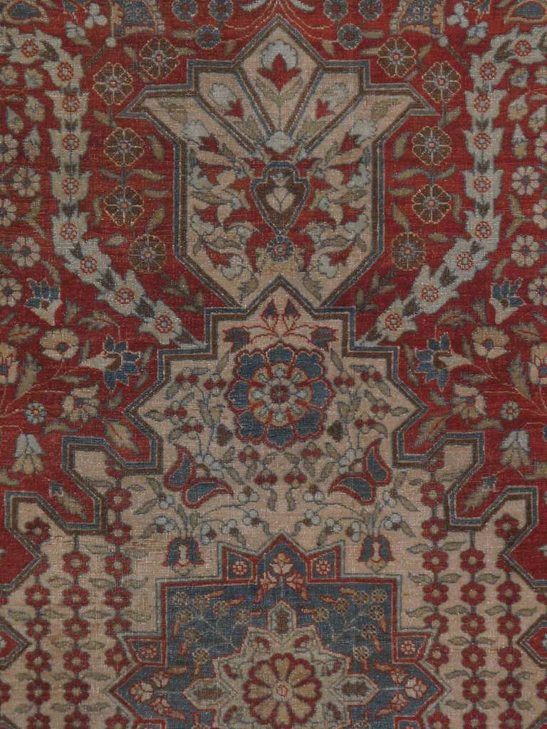 An early 20th century Persian Tabriz.  Since the 17th century, Iran started exporting artisan carpets around the world, especially to Europe.  Artists used one of the three versions of vertical looms later referred to as a Tabriz Loom.  Artists