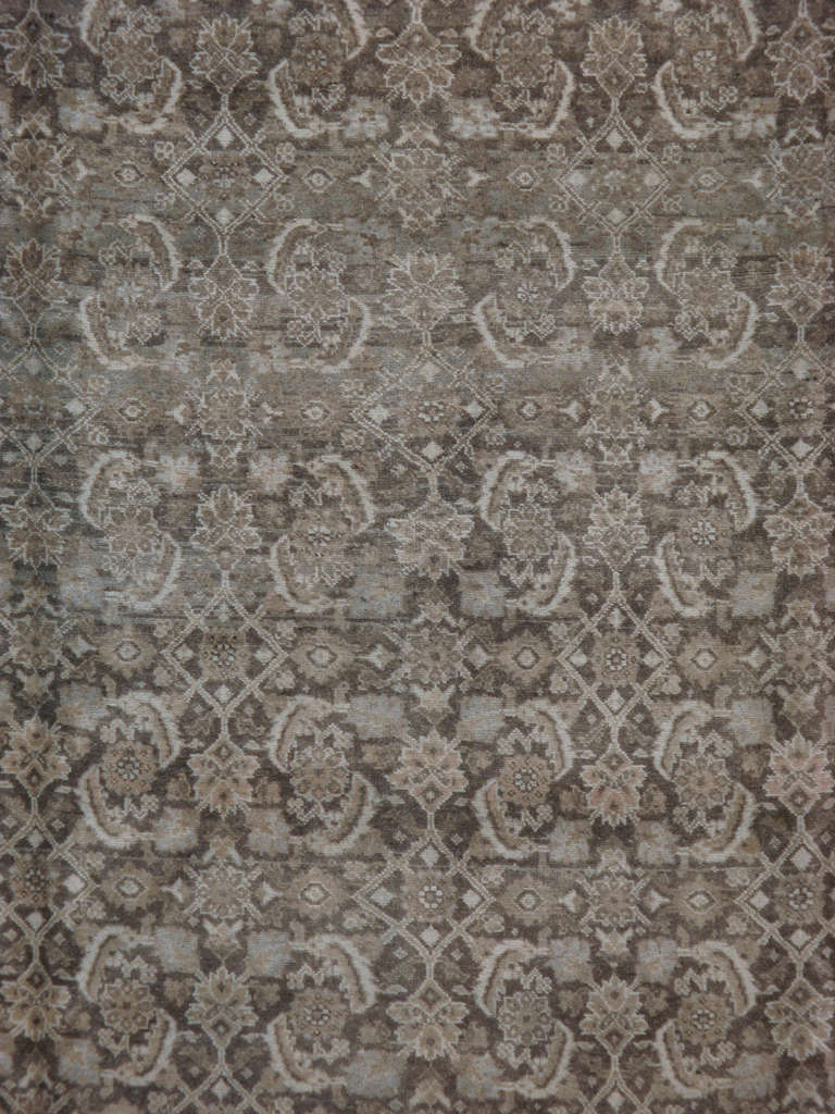 A classic early 20th century Persian Tabriz carpet featuring a herati pattern set on a brown/gray ground, accents of sky blue.  
Since the 17th century, Iran started exporting artisan carpets around the world, especially to Europe.  Artists used