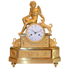 French Empire clock showing a seated cupid with his dog