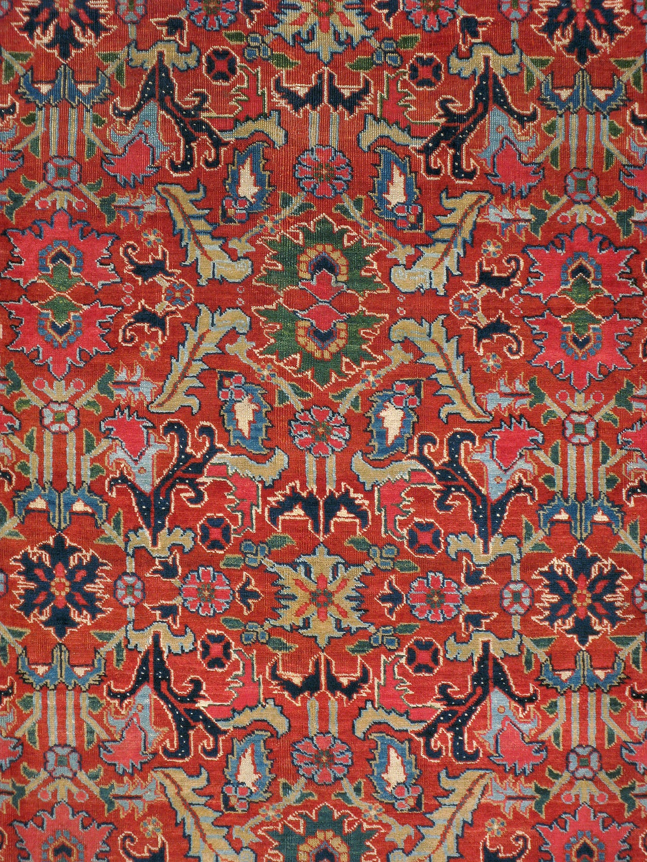 An antique Persian Heriz carpet from the first quarter of the 20th century. Heriz is the largest of the weaving towns. Most of these rugs feature a central geometric medallion surrounded by a lighter field within a geometric design scheme. Heriz