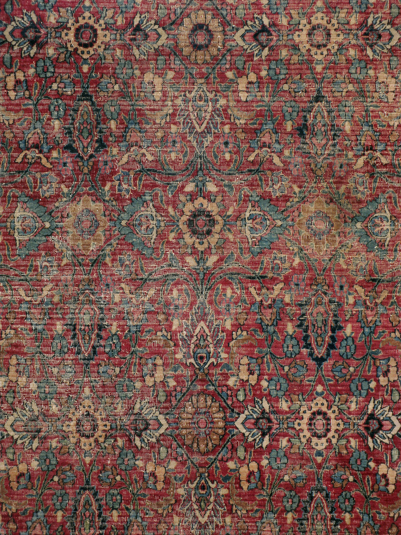 An antique distressed Persian Khorassan carpet from the first quarter of the 20th century.