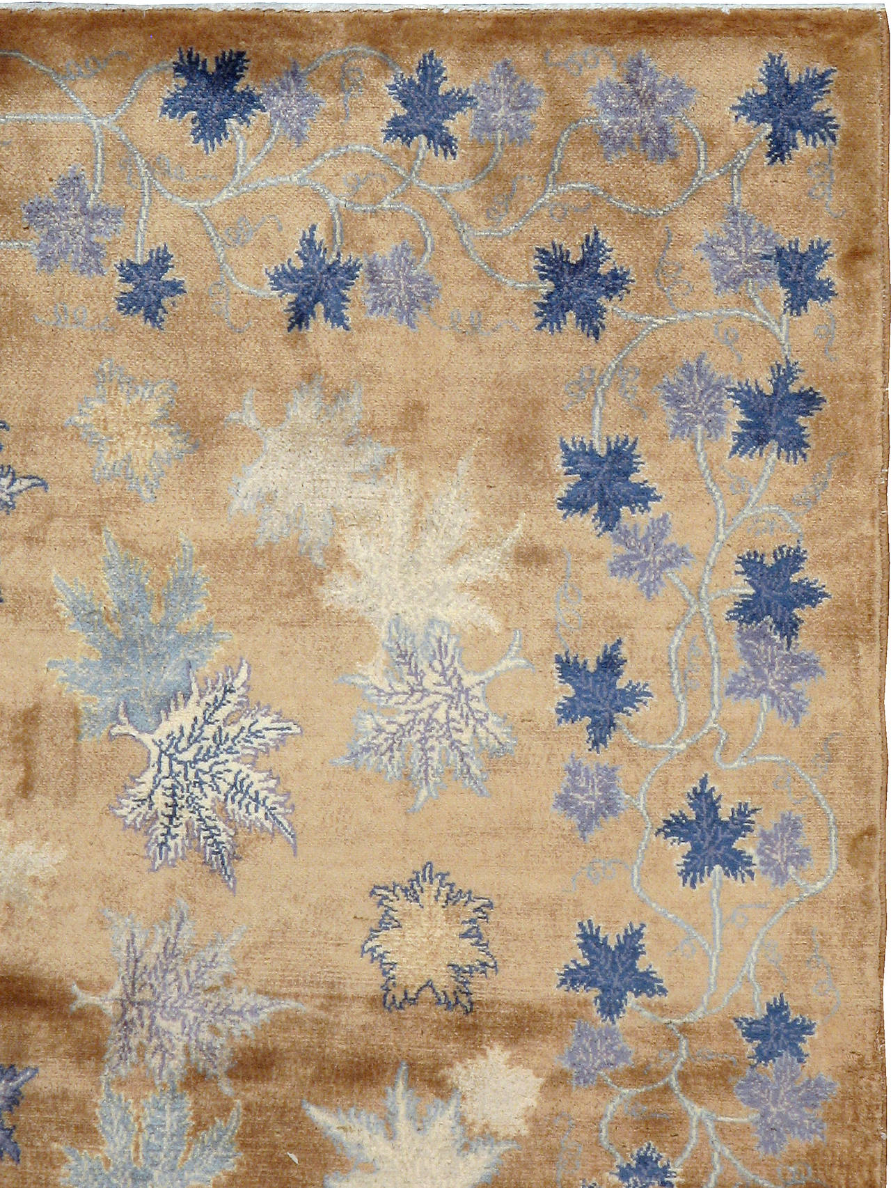 A vintage Persian Meshad carpet from the second quarter of the 20th century with an all-over leaf pattern set on a camel ground; part of a conglomerate of rugs influenced by the modernist movement.