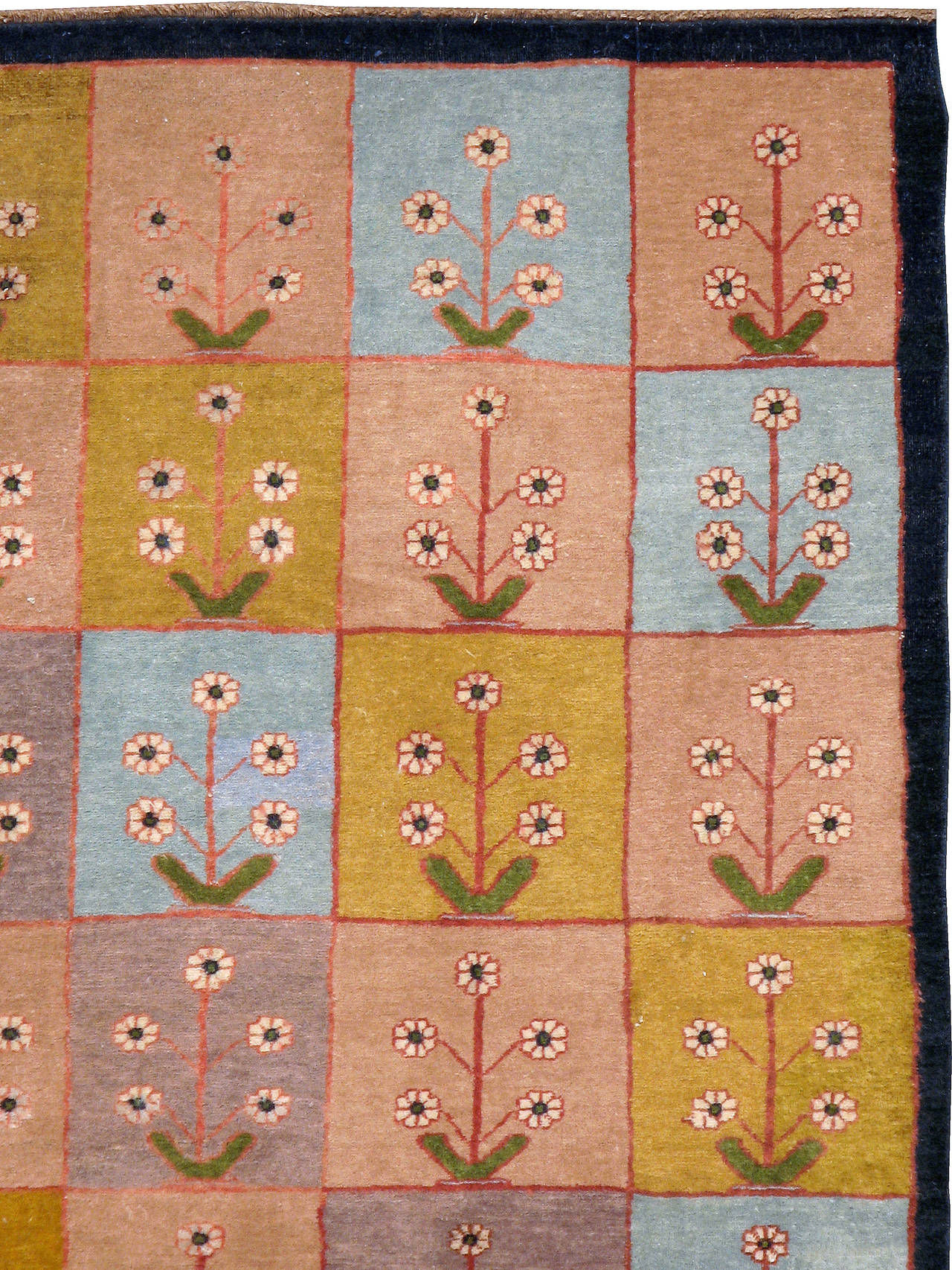 A mid-20th century vintage Indian. An Indian rug featuring a panel design consisting of flowering shrubs.
