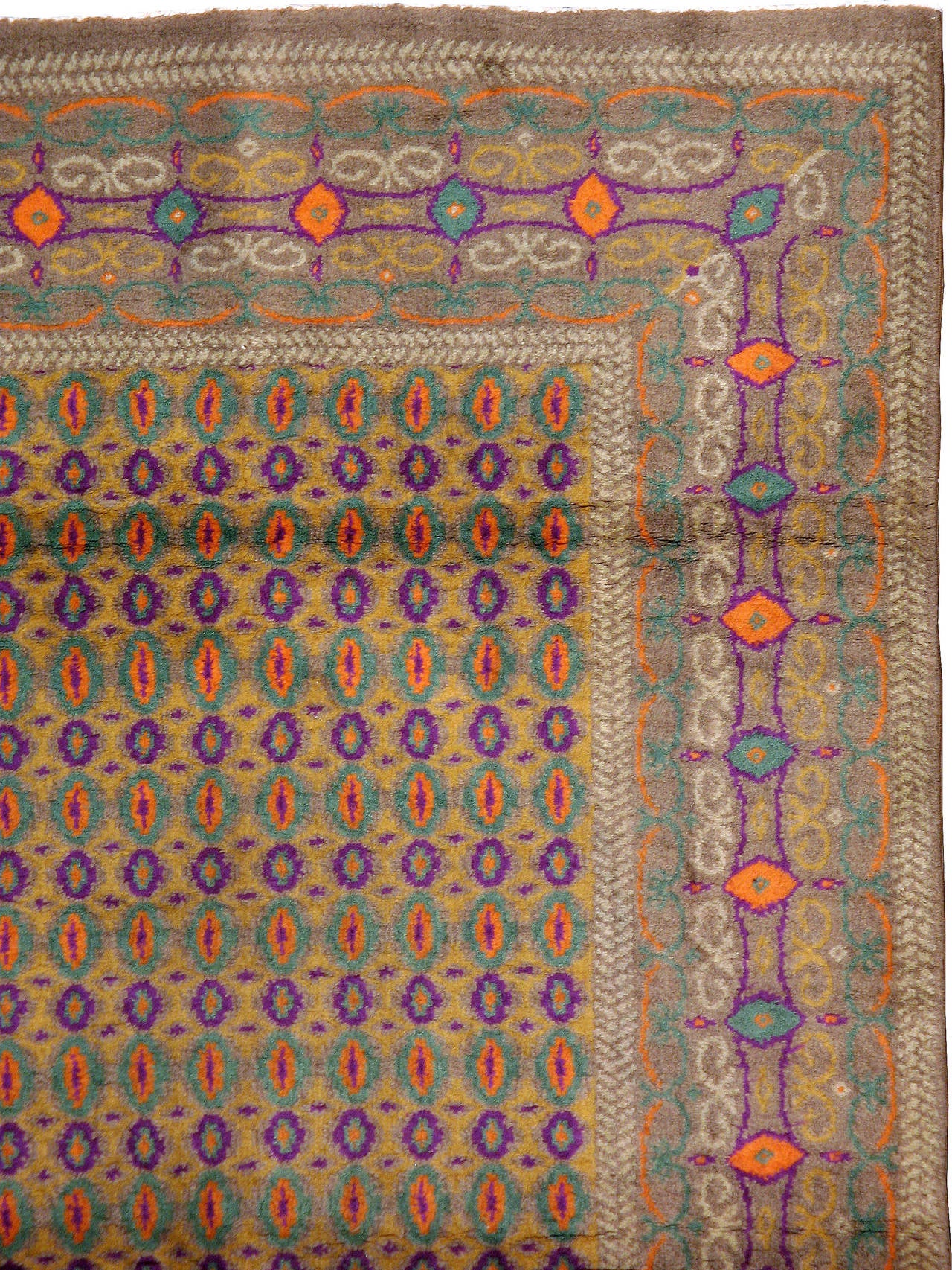 A vintage Indian Lahore carpet from the second quarter of the 20th century; part of a conglomerate of rugs influenced by the modernist movement.