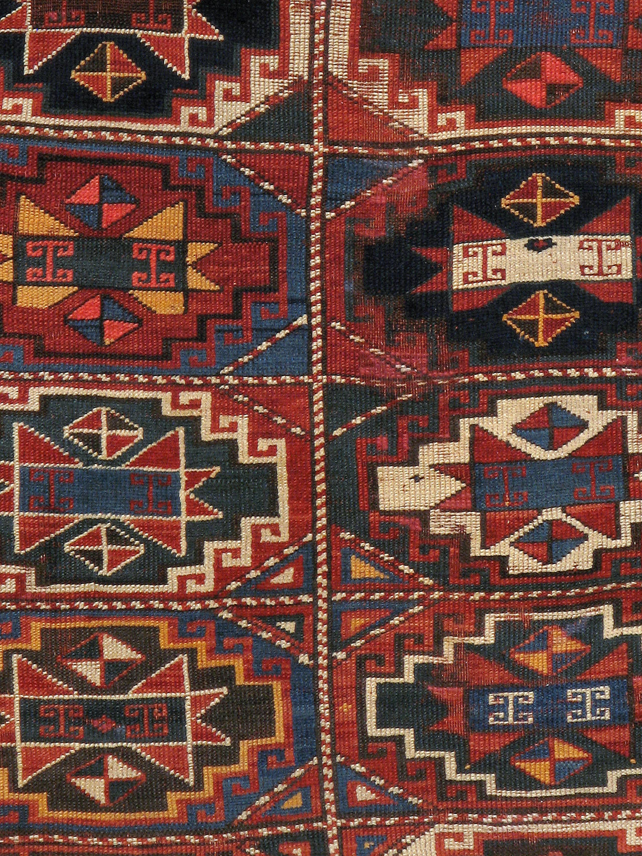 An antique Caucasian Kazak carpet from the turn of the 20th century.