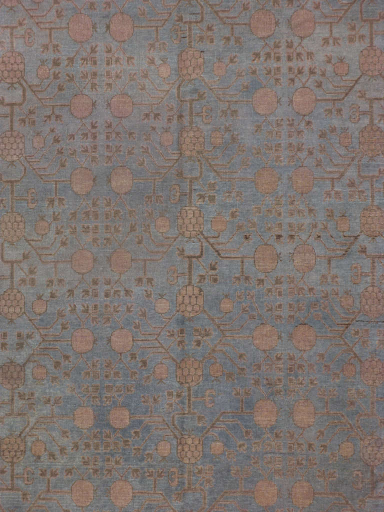 An early 20th century East Turkestan Khotan.  Antique Khotan rugs and carpets were produced in the oasis town of Eastern Turkestan, today part of the Xinjiang region in Western China.  This area has had a steady production of carpets since the 17th