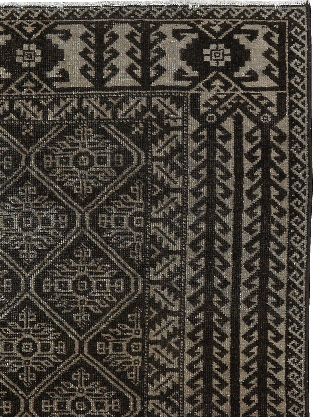An antique Persian Baluch carpet from the second quarter of the 20th century.