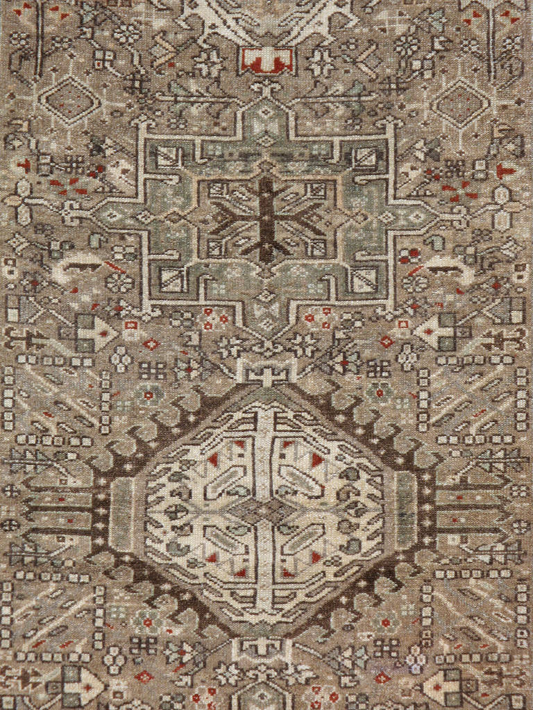 An early second quarter 20th century Persian Karajeh carpet. The Karajeh Heriz weaving district is about 40 miles east of Tabriz, Iran. Heriz is the largest of the weaving towns. Most of these rugs feature a central geometric medallion surrounded by