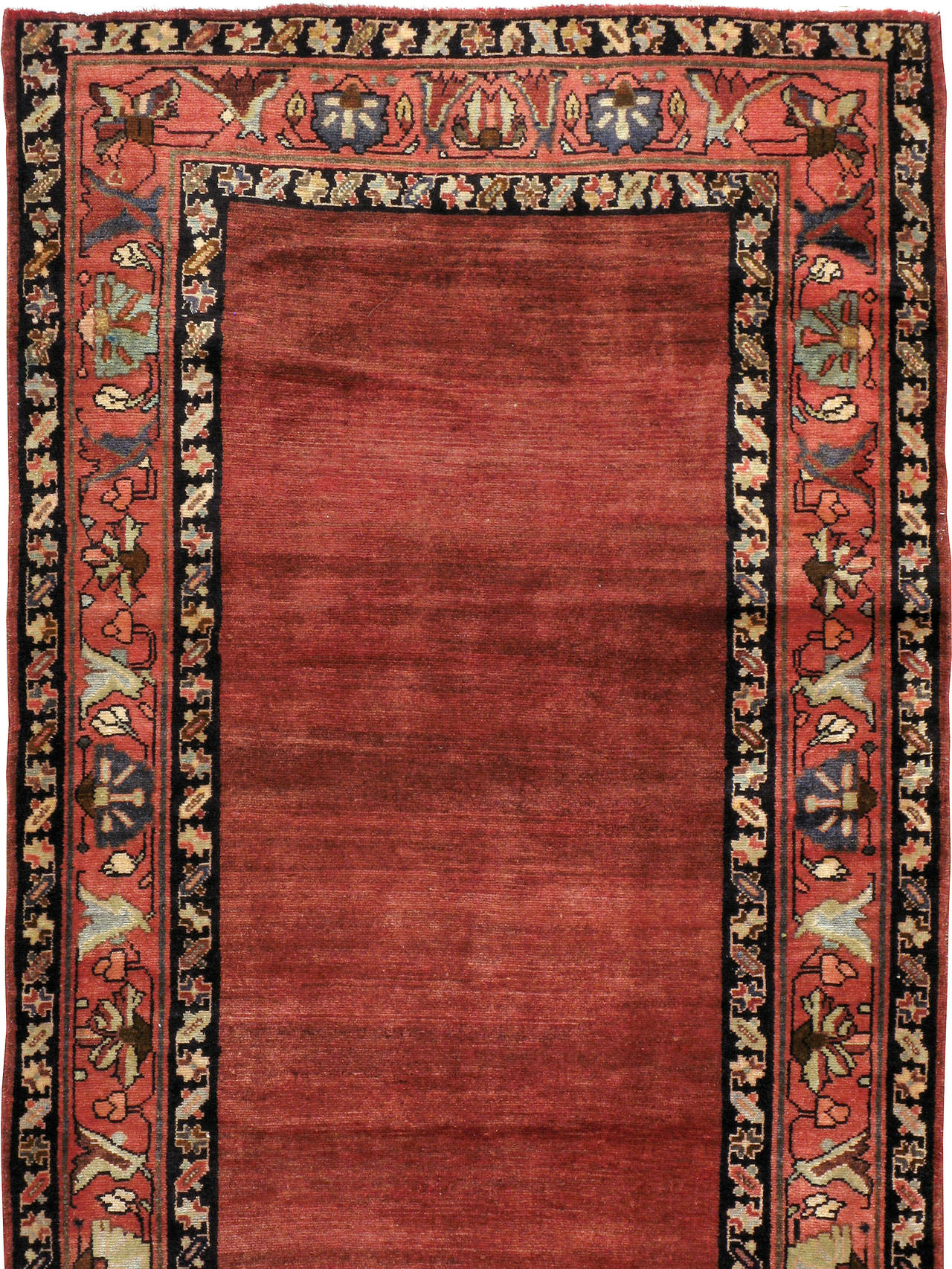 A Mid-Century Persian Mahal rug. Mahal carpets are found with both tribal and curvilinear motifs. This attribute derives from the unique position of the city of Mahallat, which is between the cities of Arak and Delijan, on the path of the tribal