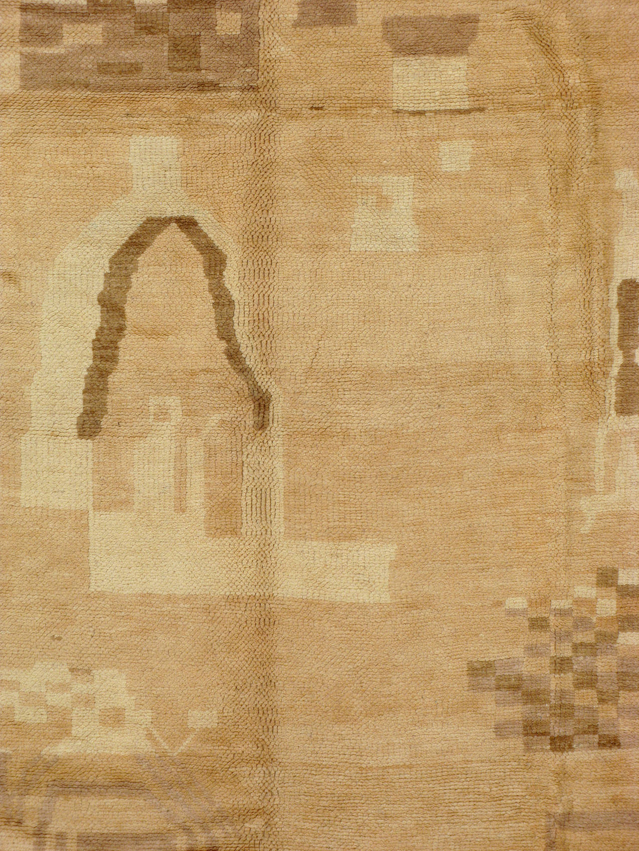 A Mid-Century Moroccan rug in a pallet of tone-on-tone hues.