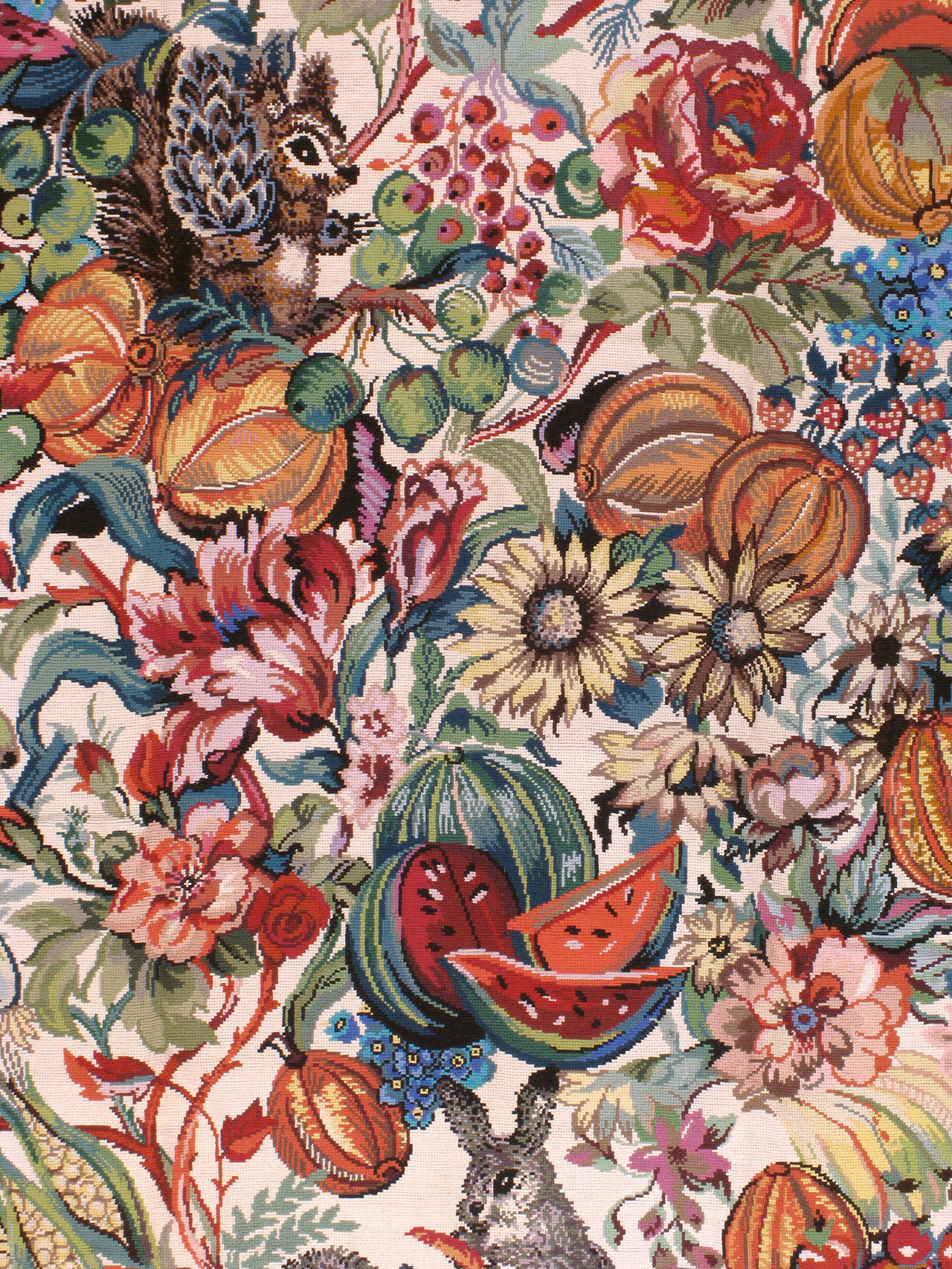 A late 20th century Portuguese needlepoint with vibrant motifs of seasonal animals, flowers, fruits and vegetables.