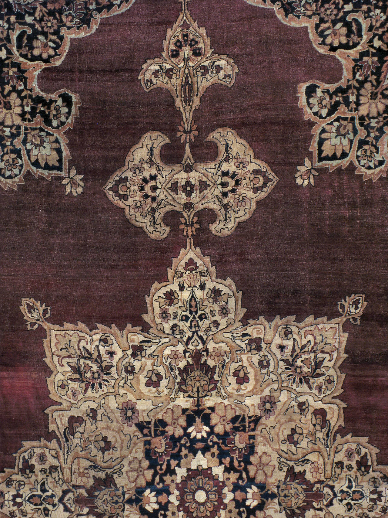 An antique Persian Lavar Kerman carpet from the turn of the 20th century.