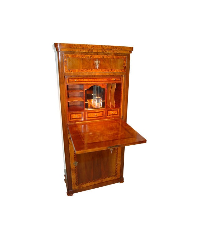 Biedermeier Secretaire made of walnut, root wood and ebony with a fall front writing surface, inside drawers and mirrored cubby hole.