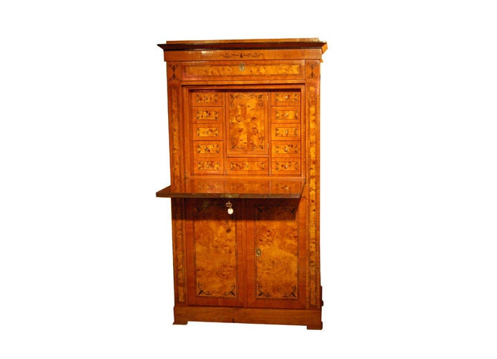 Biedermeier secretaire made of walnut, root wood and ebony with a fall front writing surface, interior drawers and secret compartments.