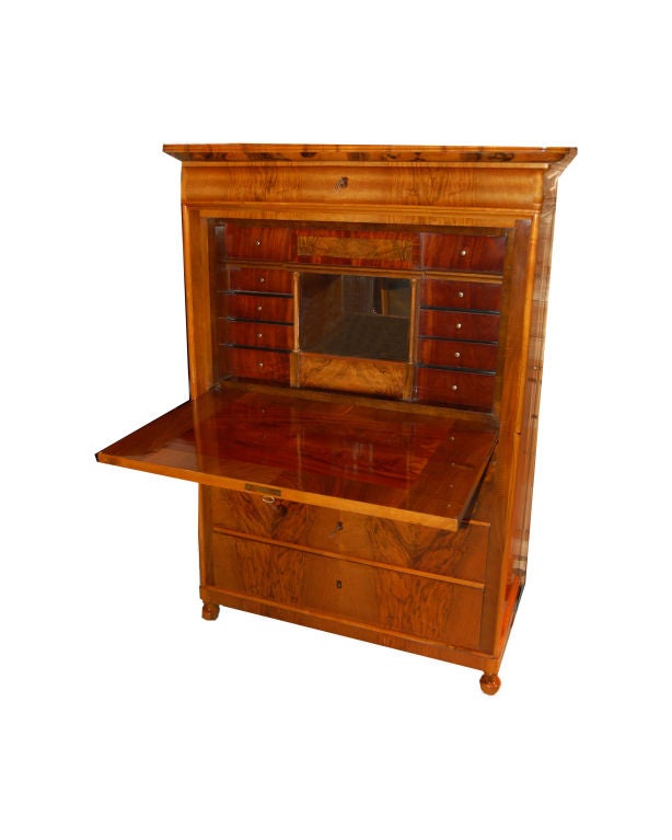 Biedermeier secretaire made of walnut and cherry with fall front writing surface, nine interior drawers, mirrored cubby hole and three exterior drawers.  Germany circa 1840.