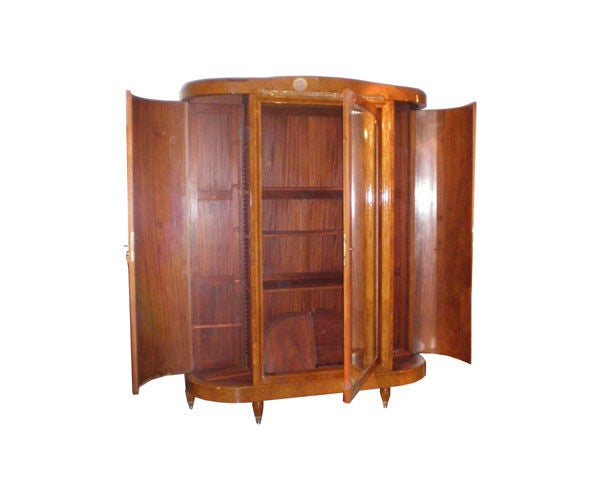 French Art Deco armoire made of amboyna burl with marquetry and inlaid mother-of-pearl. Large rectangular mirrored center door and two large side doors all with interior shelves.