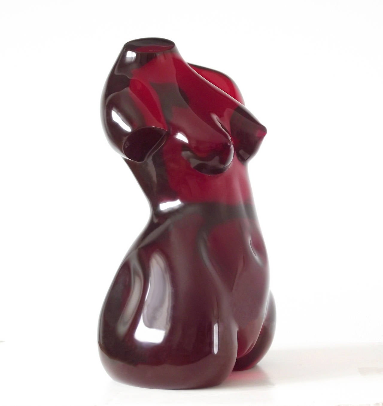 A 20th century Venus sculpture that juxtaposes the classic form with a modern medium of solid, crimson red acrylic; the perfectly smooth and lustrous surface heightens the figure's sensuality. Impressive from every angle and quite heavy at nearly 20