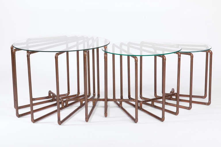 Title: Tri-Table
Year: 2006

An elegant coffee table comprised of fins radiating from a central point and held together at the base to create a light, open structure. Each of the three tiers steps down within the structure of the table,