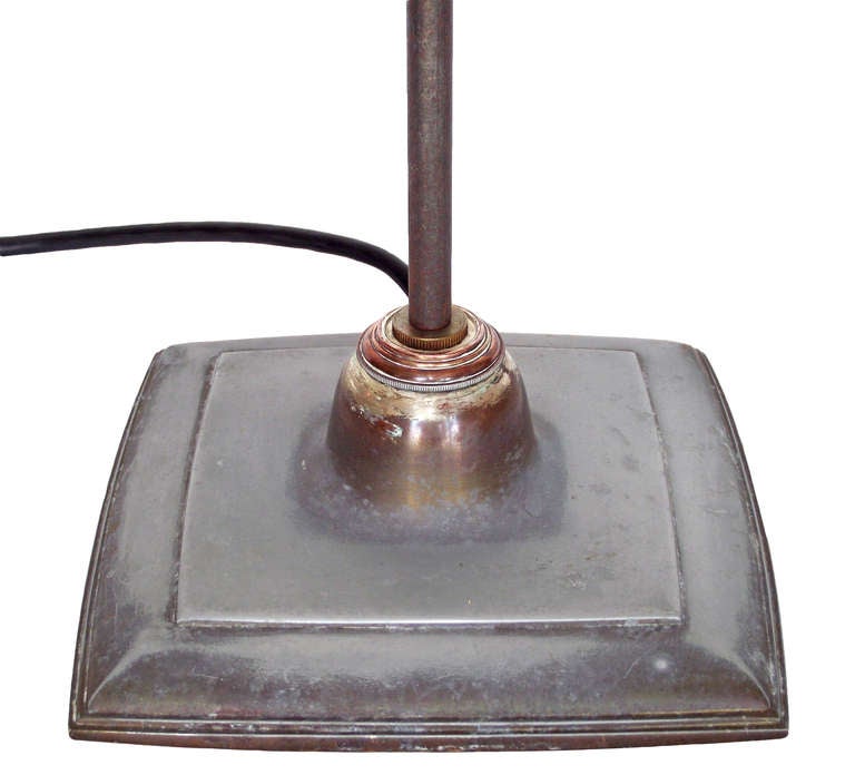A large, articulated table/task lamp designed by O.C. White, circa 1940. This particular example is mounted to its original, decorative base (with a solid copper section at top) - - very unusual as most White lamps of this size have a clamp mount.